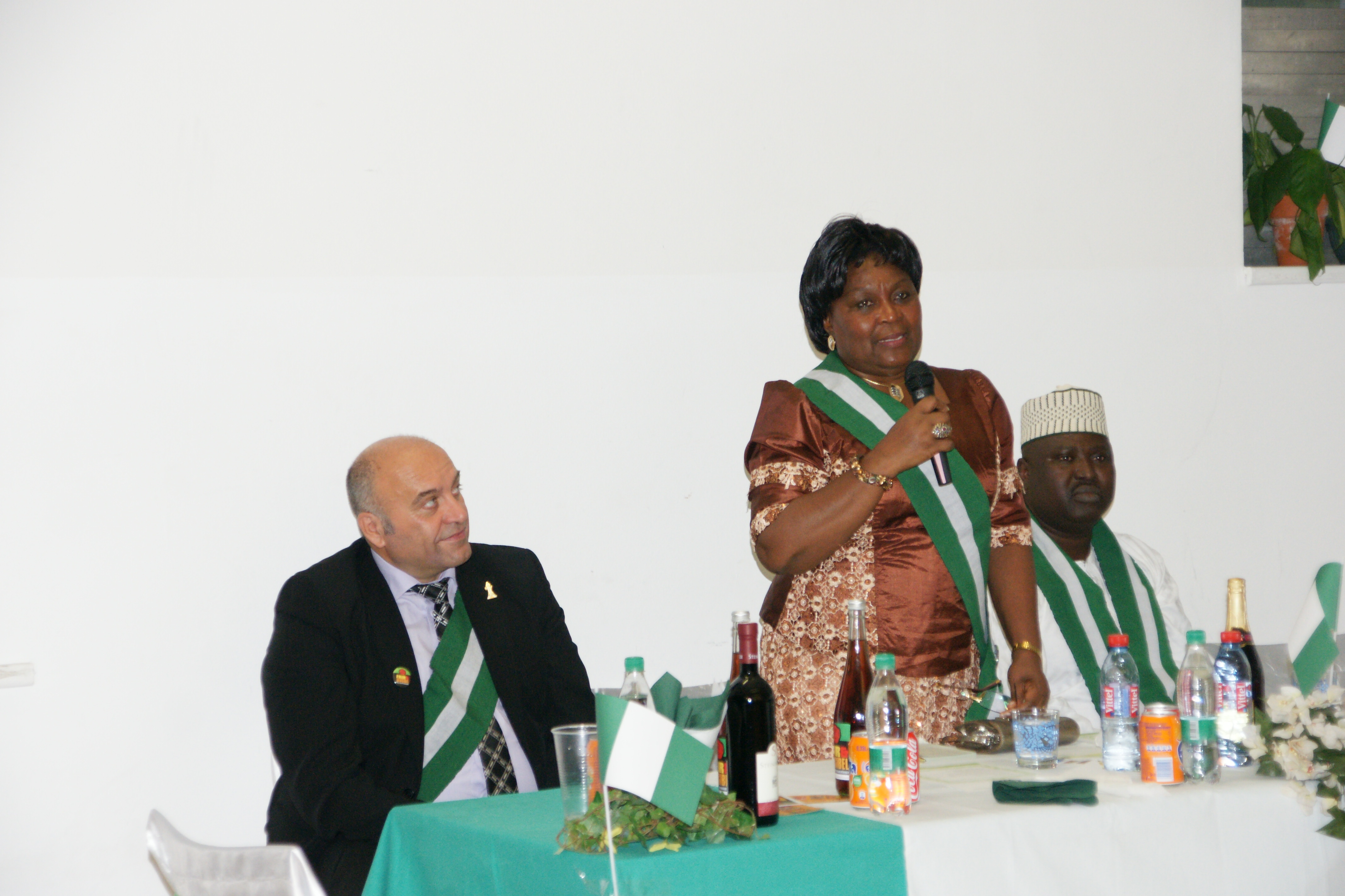 Ambassador Maria Laose surrounded by Mr. Josef Boeck and Mr Oluyemi Ogundele  addressing Nigerians 