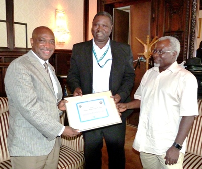 Mr. Oluyemi Ogundele, NANCA President (Middle) presenting Mr. Ayo Olukanni (left) with Certificate of NANCAs highest honour witnessed by Mr. Agbonkpolor Owa Naps, the President of Edo community Austria. Mr. Oluyemi Ogundele, NANCA President (Middle) presenting Mr. Ayo Olukanni (left) with Certificate of NANCAs highest honour witnessed by Mr. Agbonkpolor Owa Naps, the President of Edo community Austria.